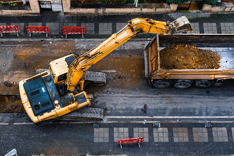 construction equipment excavates a city street to improve the wa manutenzione e costruzione ponti e infrastrutture